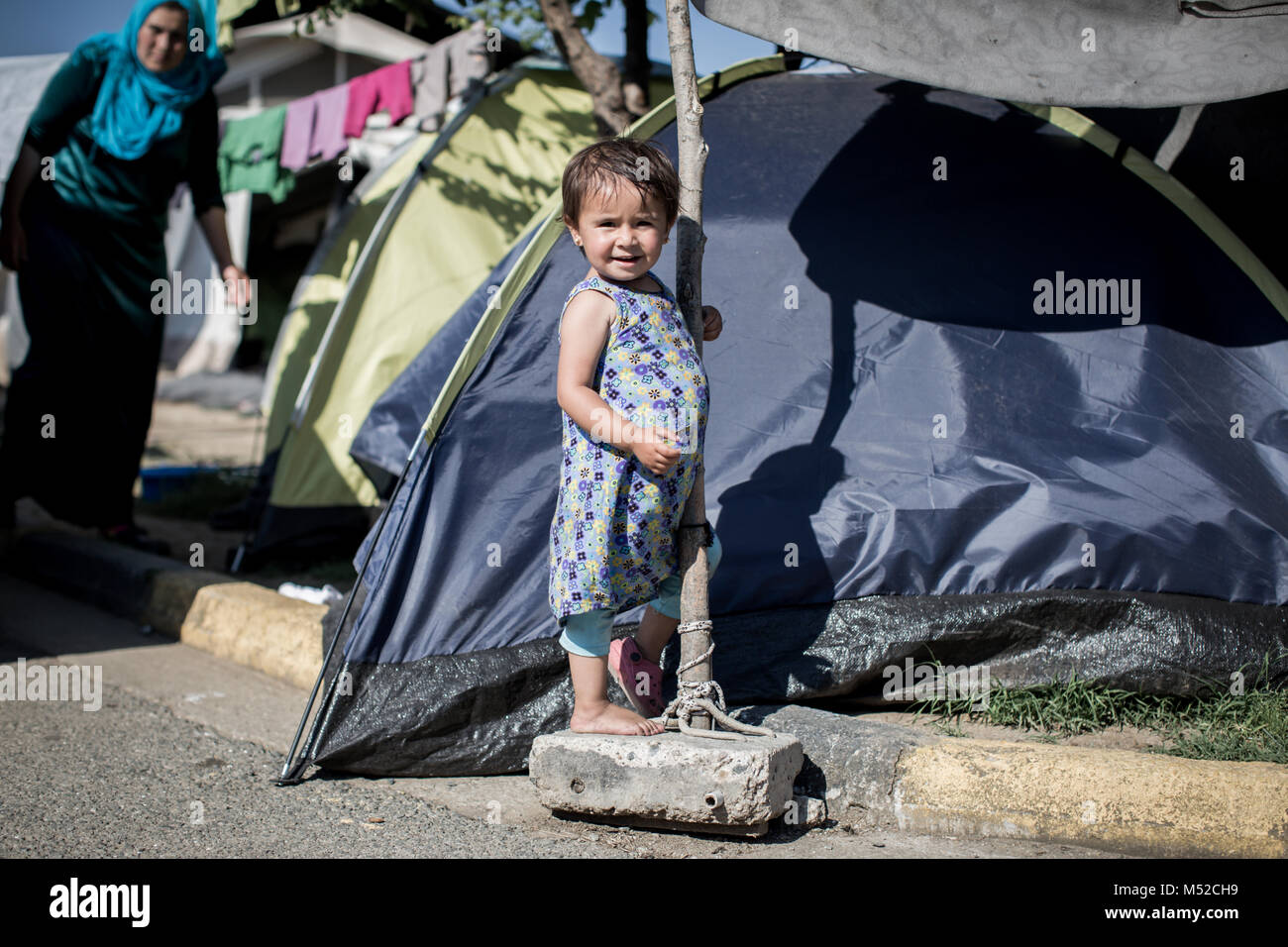 A Young Girl Seen Only With One Shoe In Idomeni Refugee Camp In ...