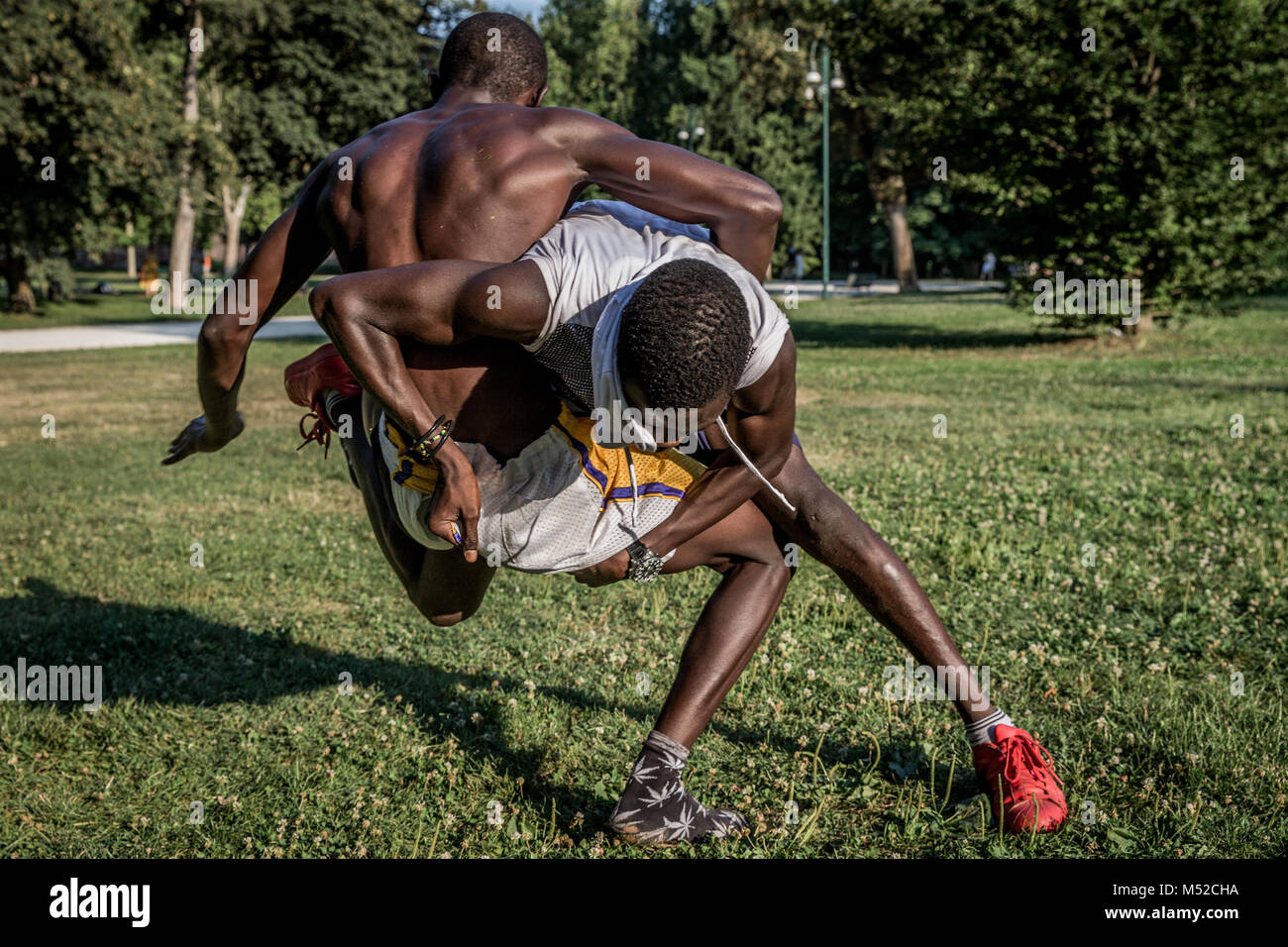 Young men seen at a Greco-Roman Wrestling training session in Milan's Sempione park Stock Photo