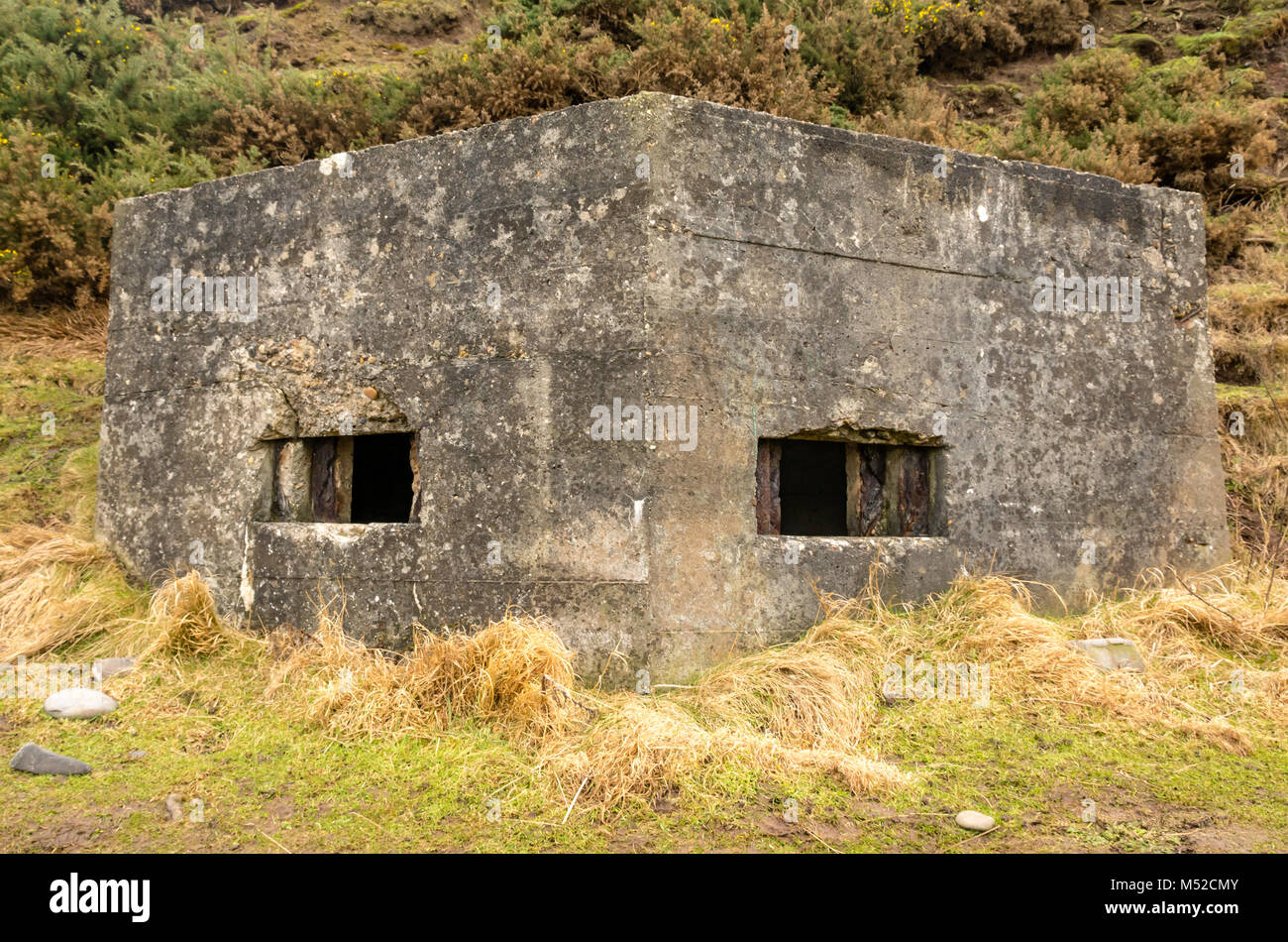 Close up of ruined concrete World War II binker wth gun hole on beach, Sandend, Moray, Scotland, UK Stock Photo