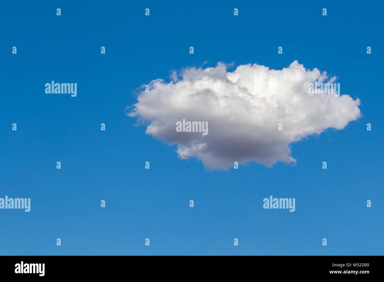 White fluffy isolated cumulus clouds against the blue sky on a bright summer day Stock Photo