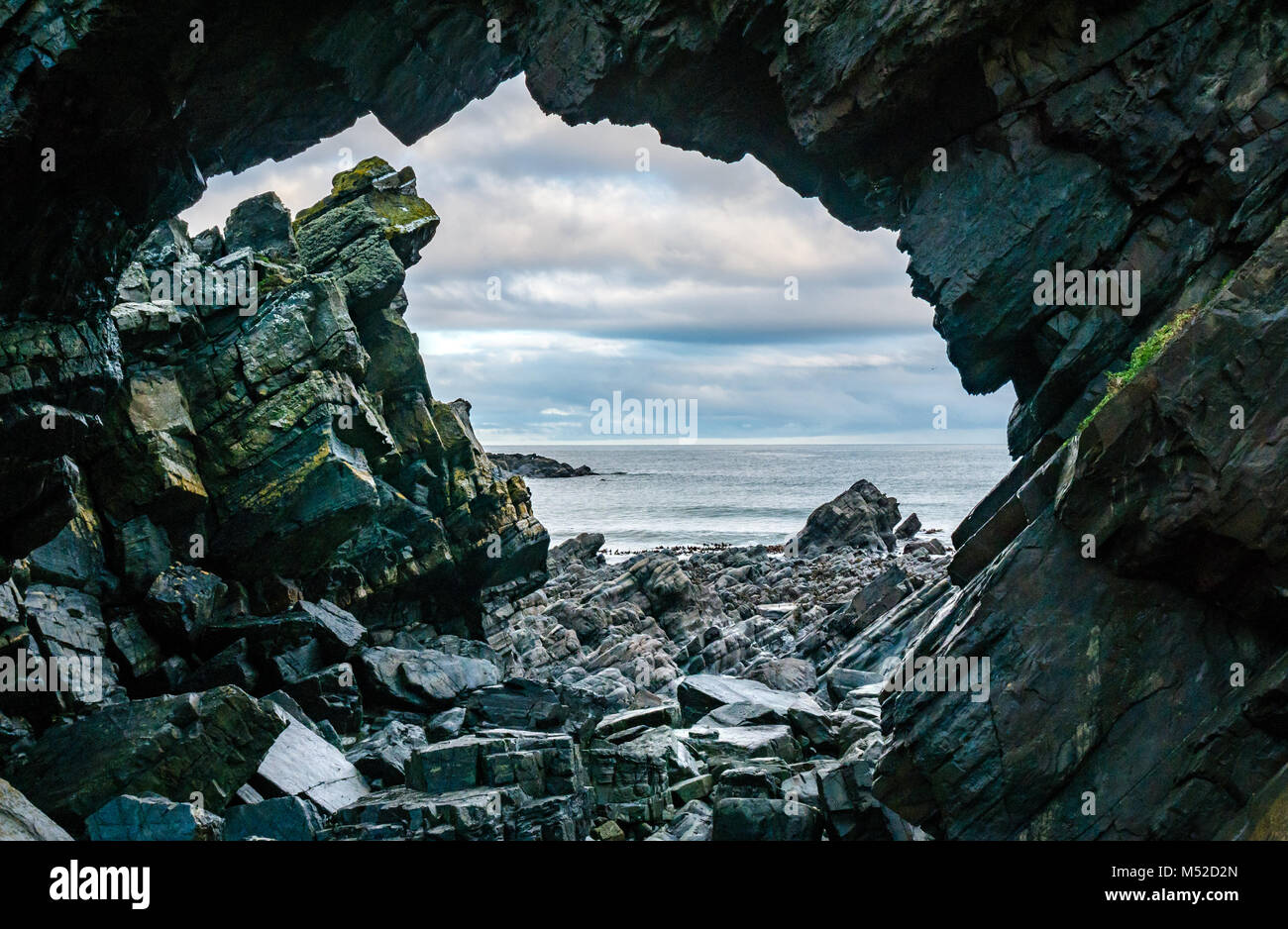 Looking through hole, natural worn sea arch, Tarlair Rock, MacDuff, Aberdeenshire, Scotland, UK Stock Photo