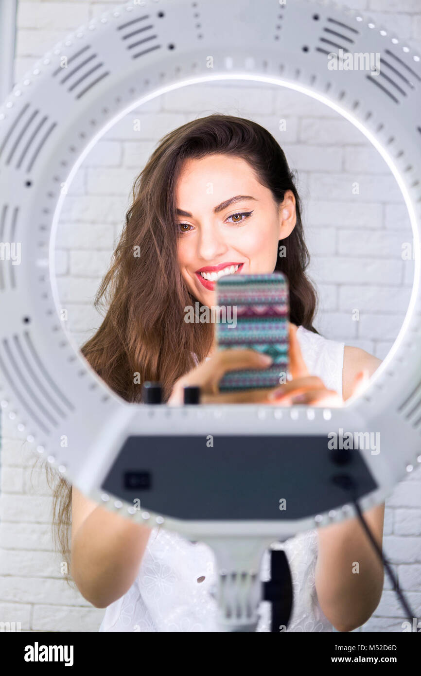 Young and beautiful woman taking selfie picture with mobile phone in ...