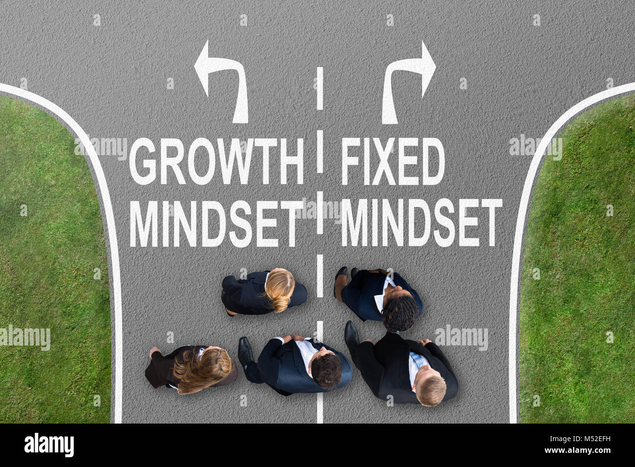 Businesspeople Standing On Road With Arrow Sign Showing Growth Mindset And Fixed Mindset Direction Stock Photo