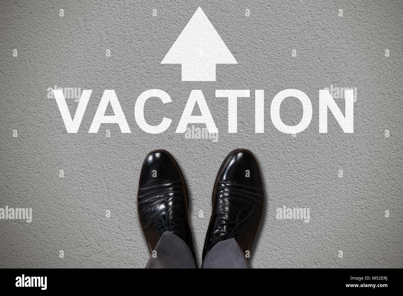 Low Section View Of Human Foot With Vacation Text And Arrow Sign Stock Photo