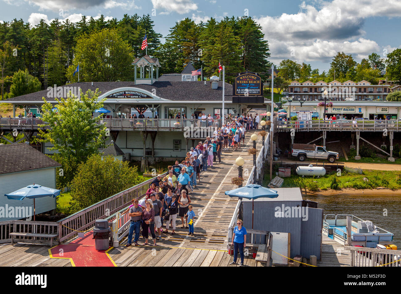 Tourists wait on the dock to ride the Mount Washington Scenic Ferry from Wiers Beach to Wolfboro, NH, USA. Stock Photo