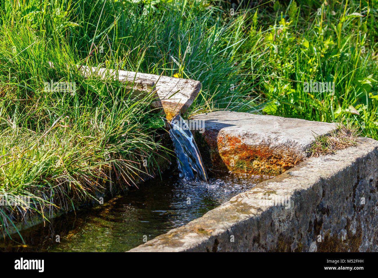 Troughs with running clear water from a spring Stock Photo