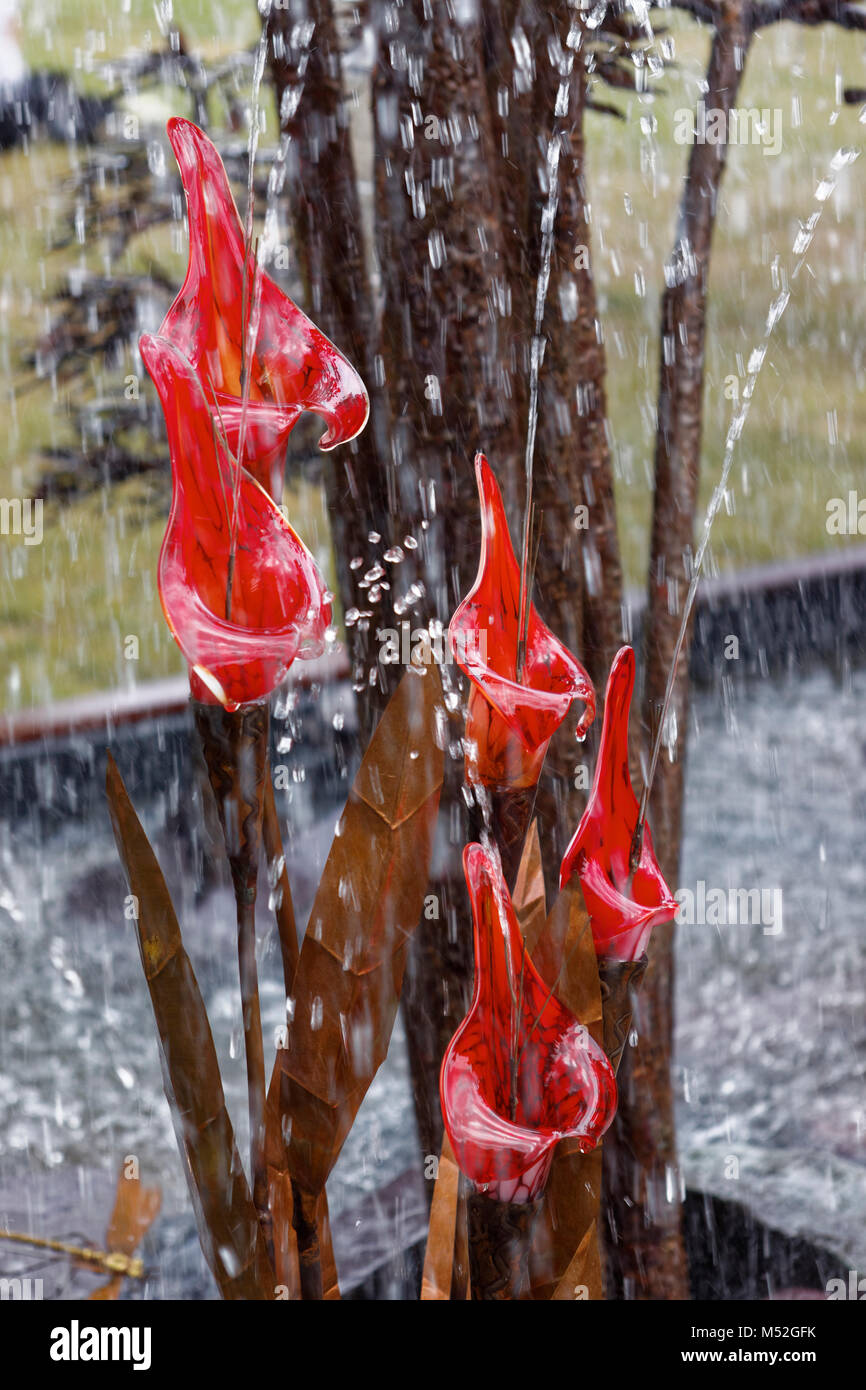 Red glass water fountains garden feature Stock Photo Alamy