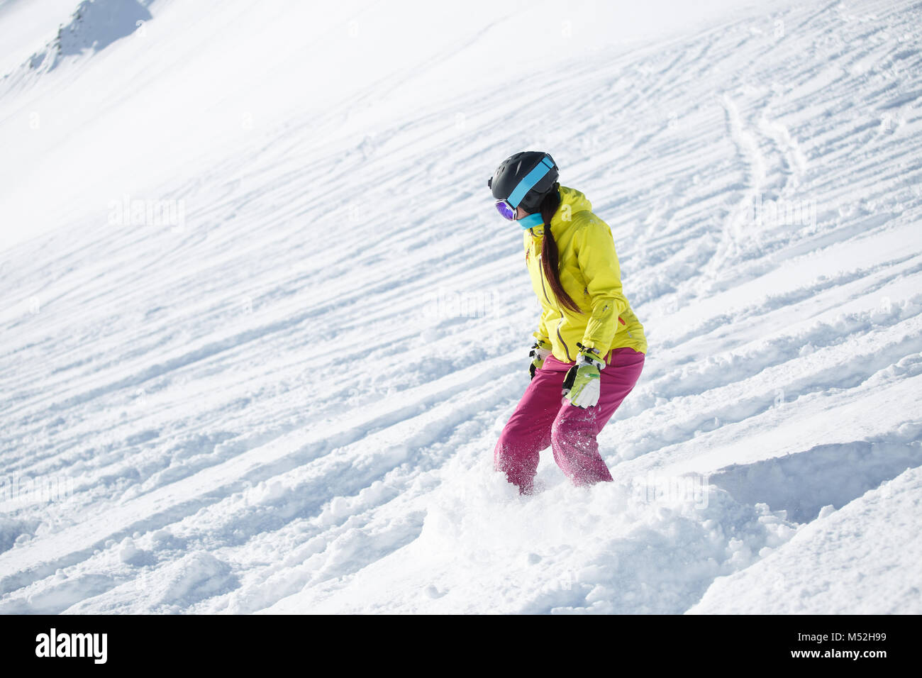 Picture of athlete in helmet and mask, snowboarding from snowy