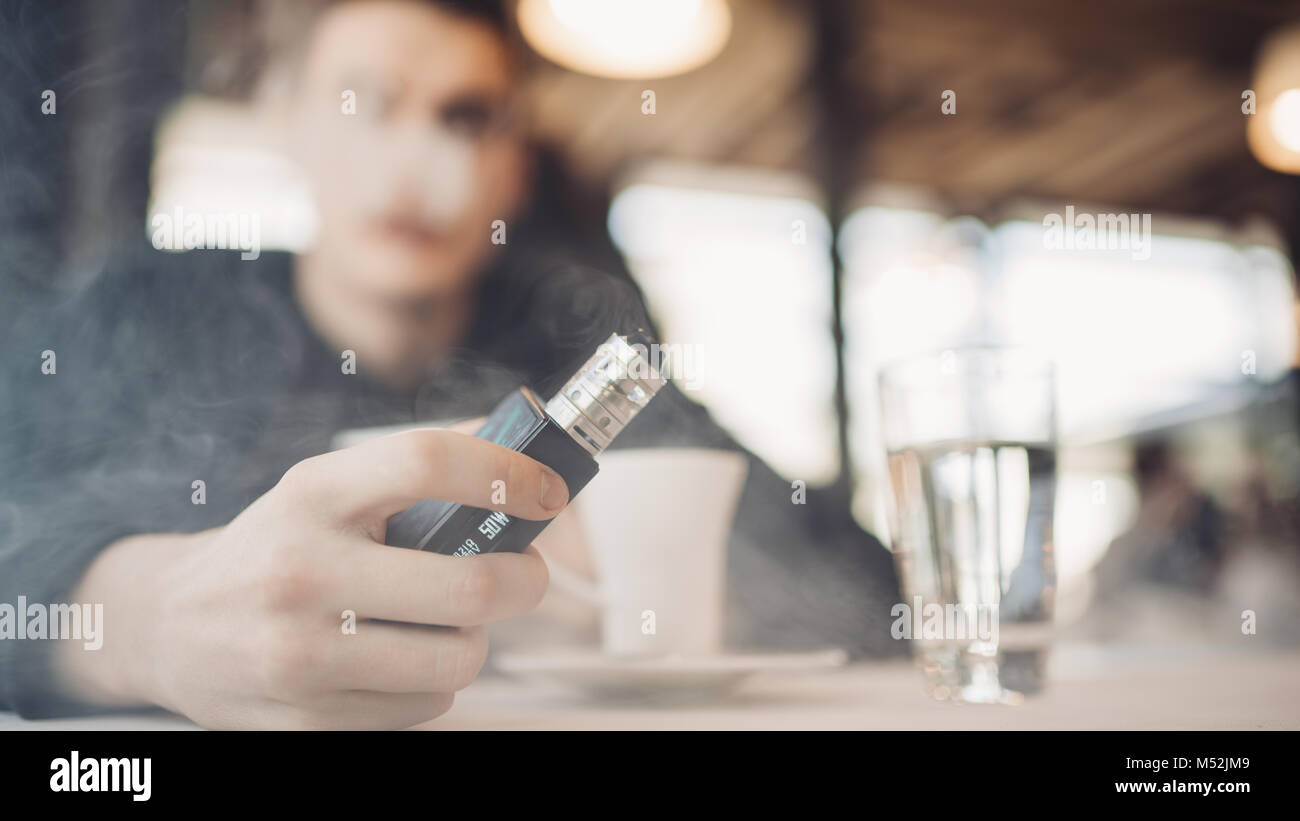 Using electronic cigarette to smoke in public places.Smoke restriction