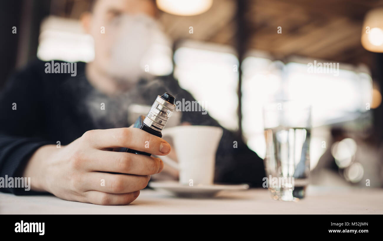 Using electronic cigarette to smoke in public places.Smoke restriction