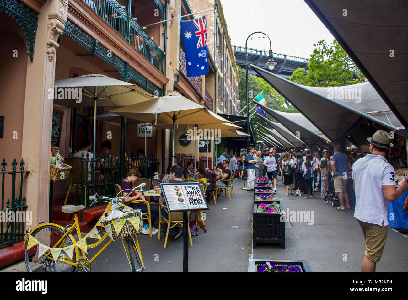 Sydney, Australia: People  at the outside terrace of a city cafe and at a street market Stock Photo