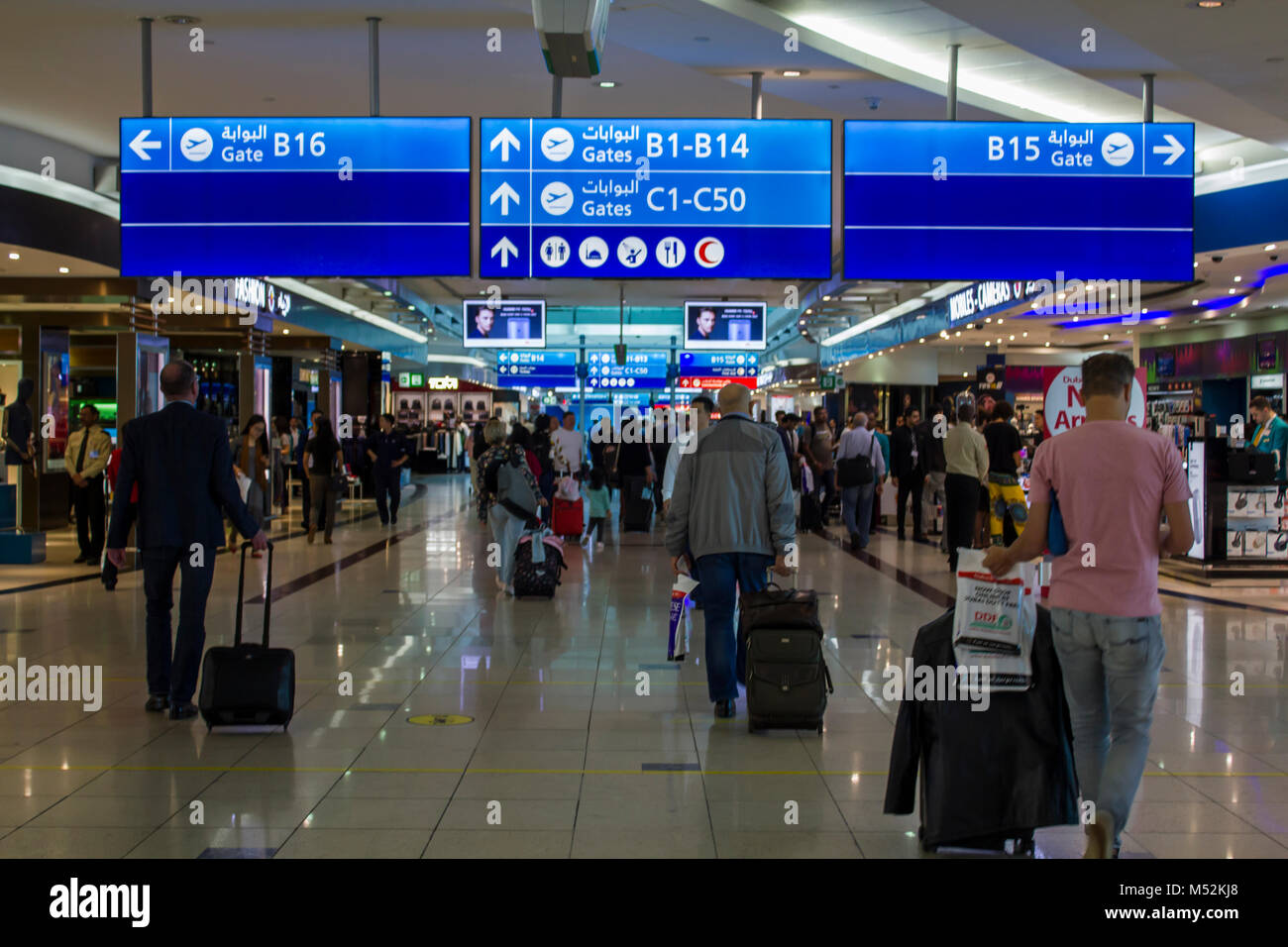 People with baggage walking in Airport duty free area Stock Photo