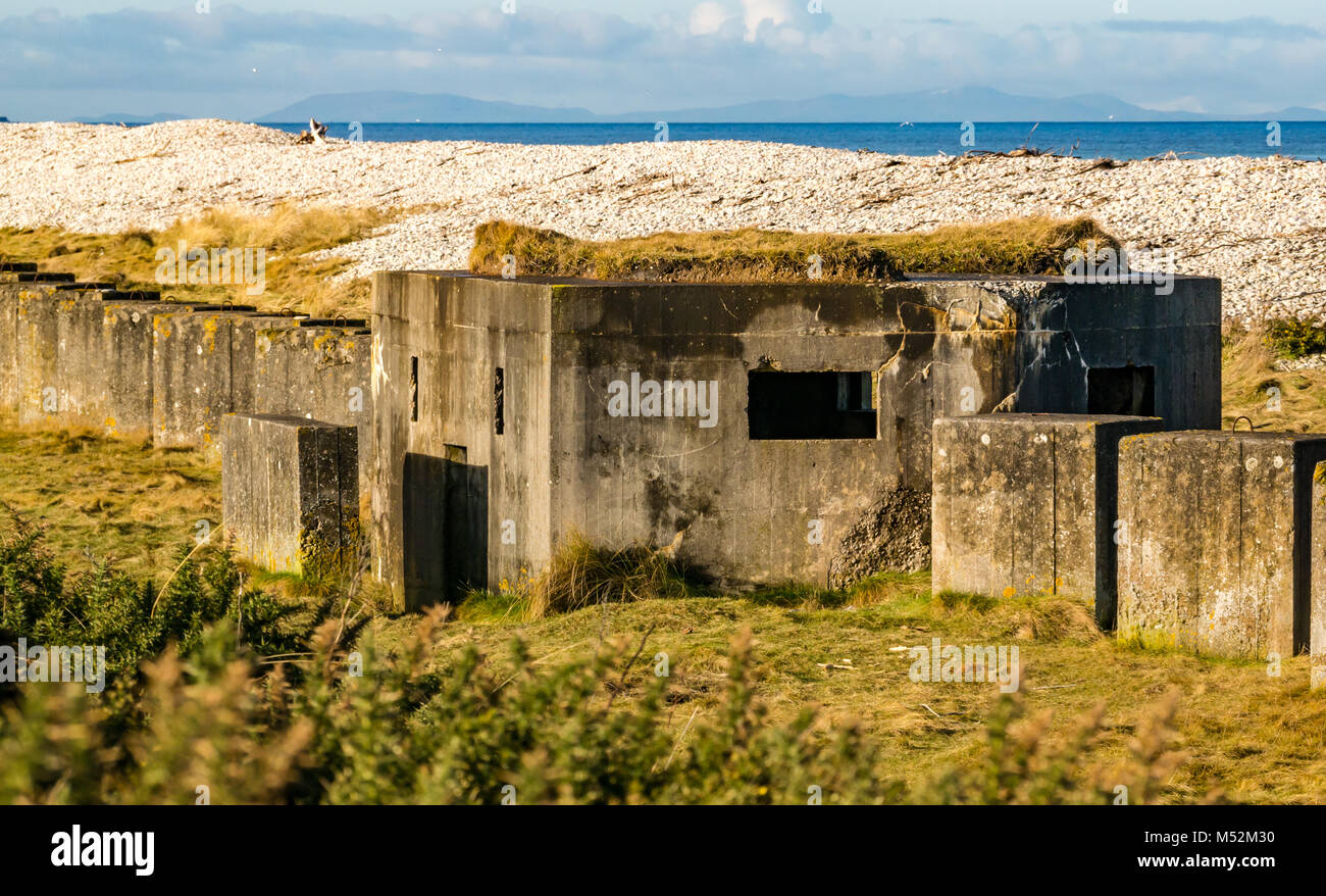 World War II defence concrete blocks and bunker in shingle beach, Spey Bay, Moray, Scotland, UK Stock Photo