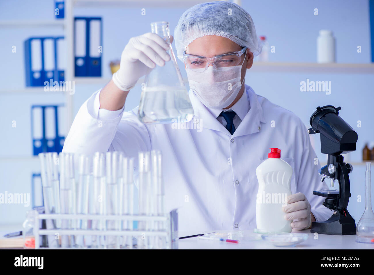 Man in the lab testing new cleaning solution detergent Stock Photo Alamy