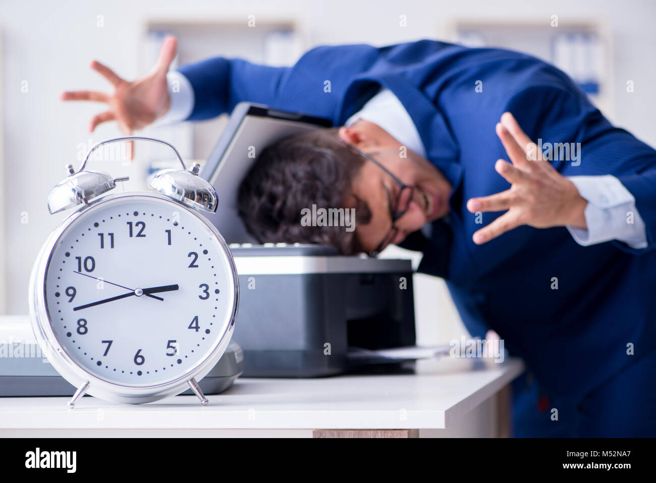 Businessman making copies in copying machine Stock Photo - Alamy