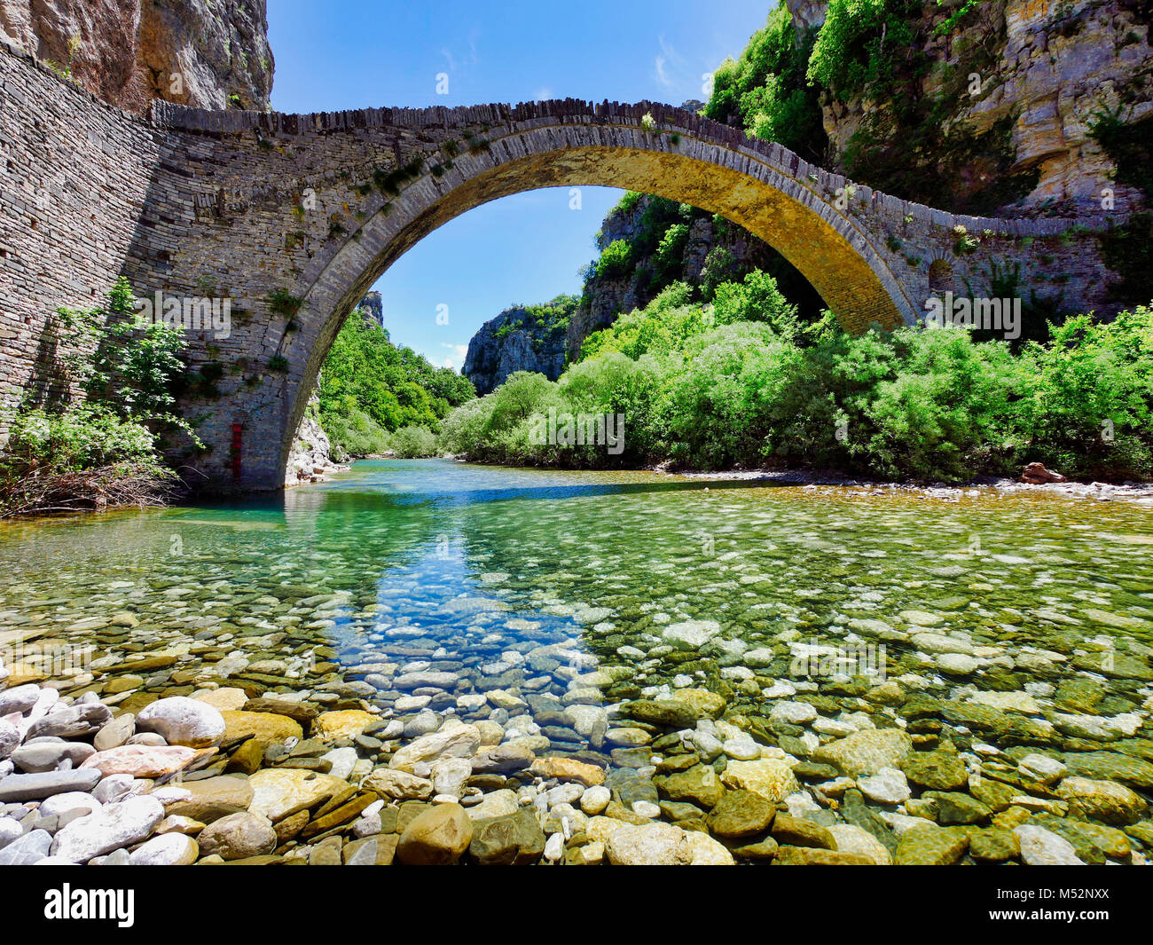 Old ancient Kokkori arched stone bridge Noutsou Zagori at Epiros, Pindos mountains in Greece Stock Photo