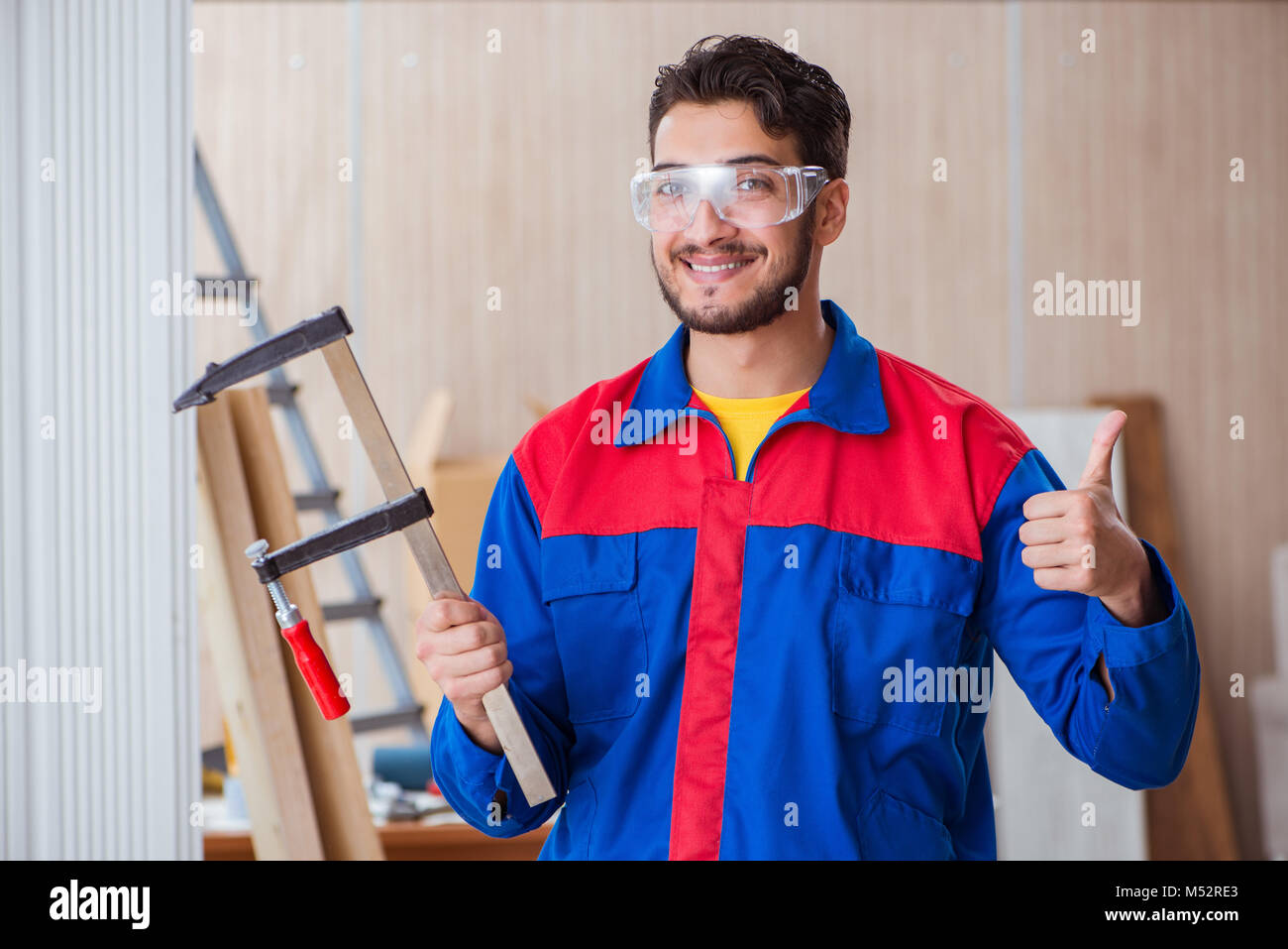 The young repairman carpenter working with clamps Stock Photo