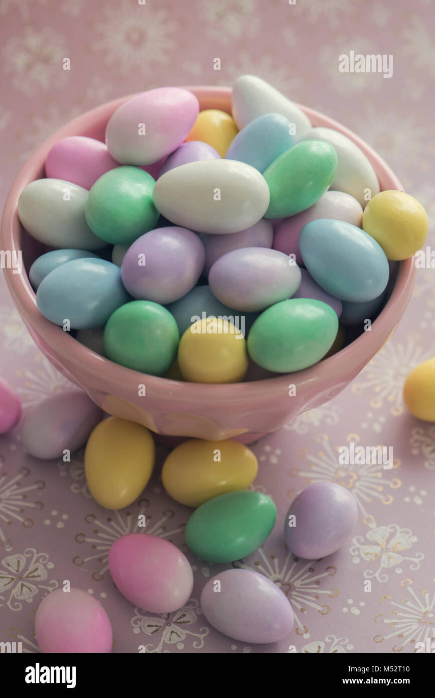 Jordan Almonds in a pink bowl on a pastel background Stock Photo