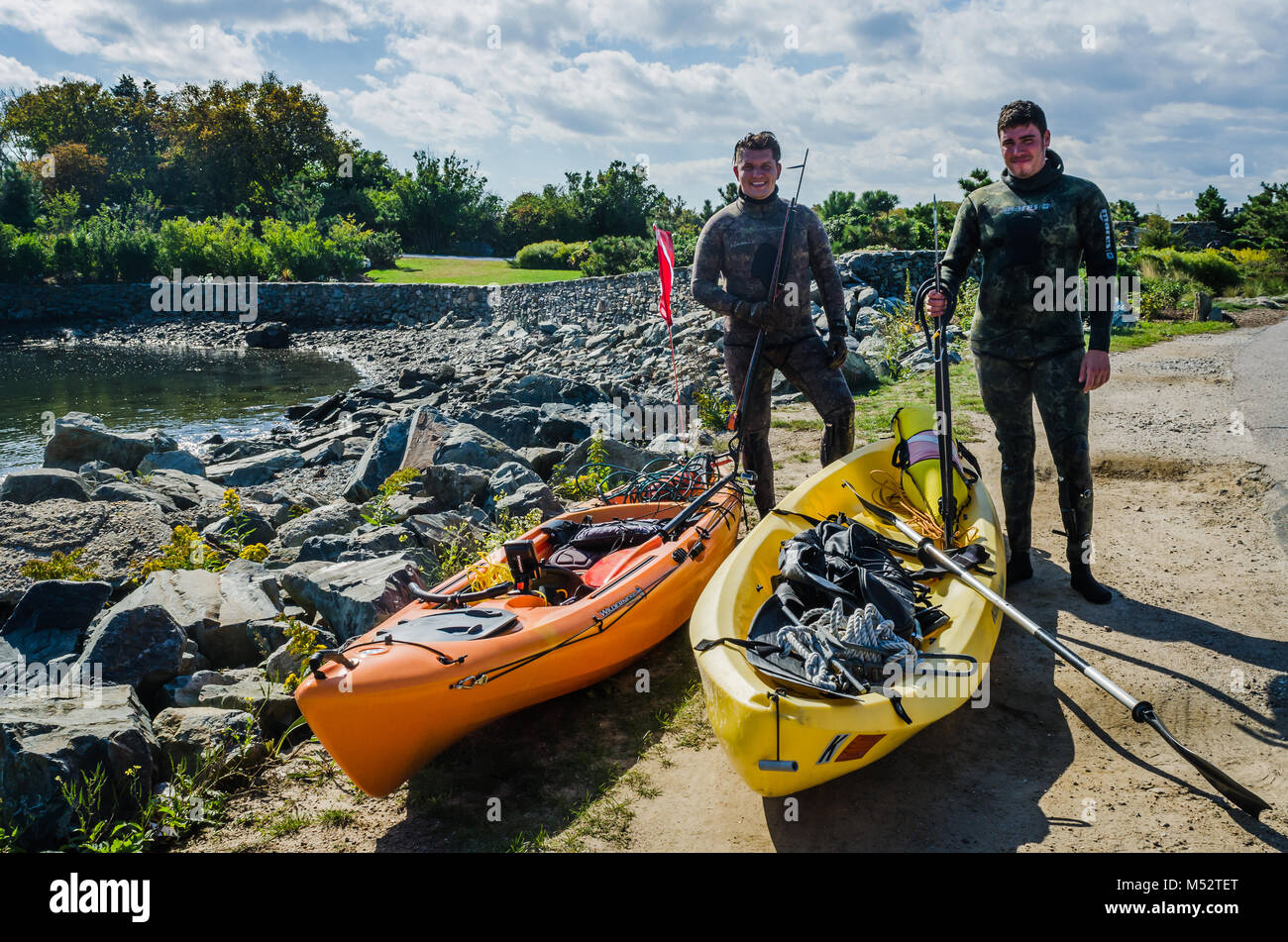 Two lobster spearfishermen about to go spearfishing with kayaks in Newport, Rhode Island, USA. Stock Photo