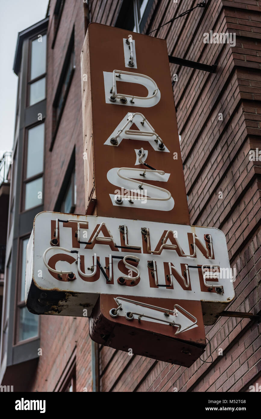 Neon sign pointing to Italian Cuisine, symbolic of the Italian immigrant impact on the North End neighborhood of Boston, Massachusetts. Stock Photo