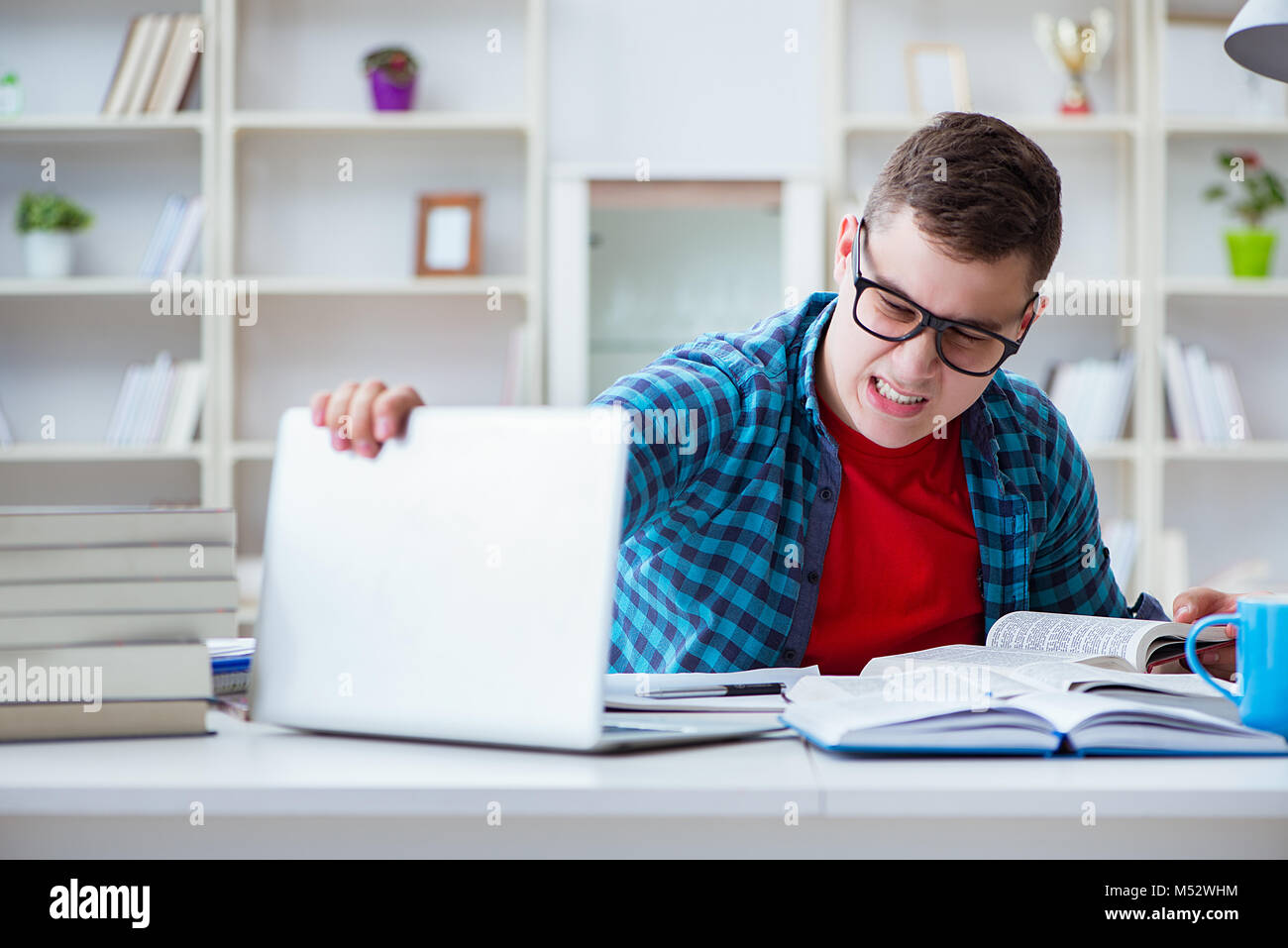 Student Preparing Young teenager preparing for exams studying at a desk indoors Stock ...