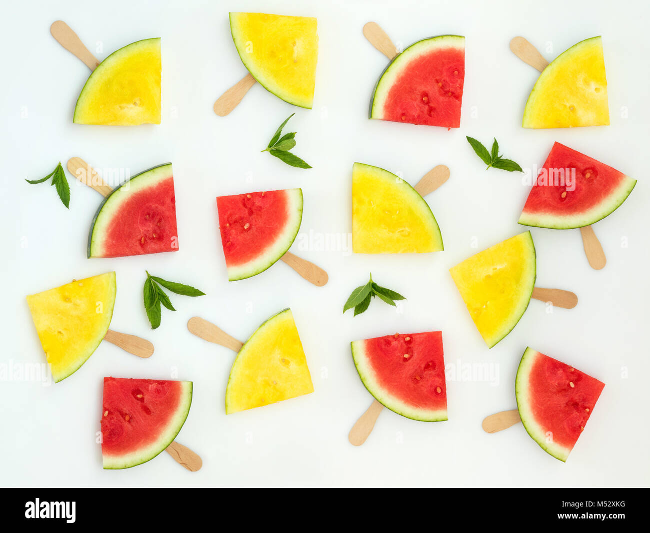Red and yellow watermelon slices on sticks Stock Photo