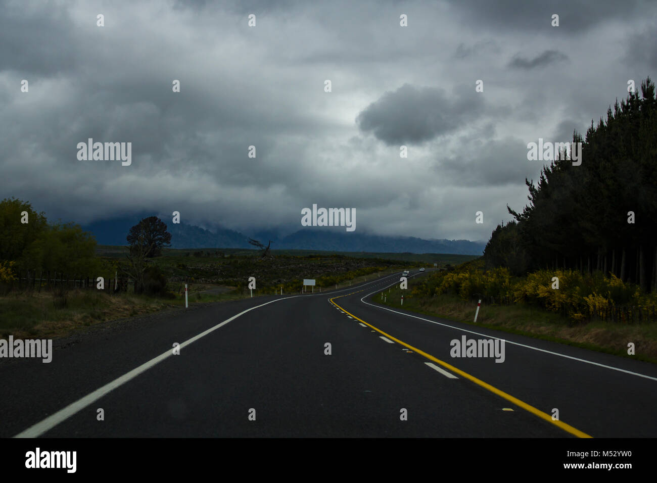 New Zealand scenic Asphalt Road with stormy sky Stock Photo - Alamy