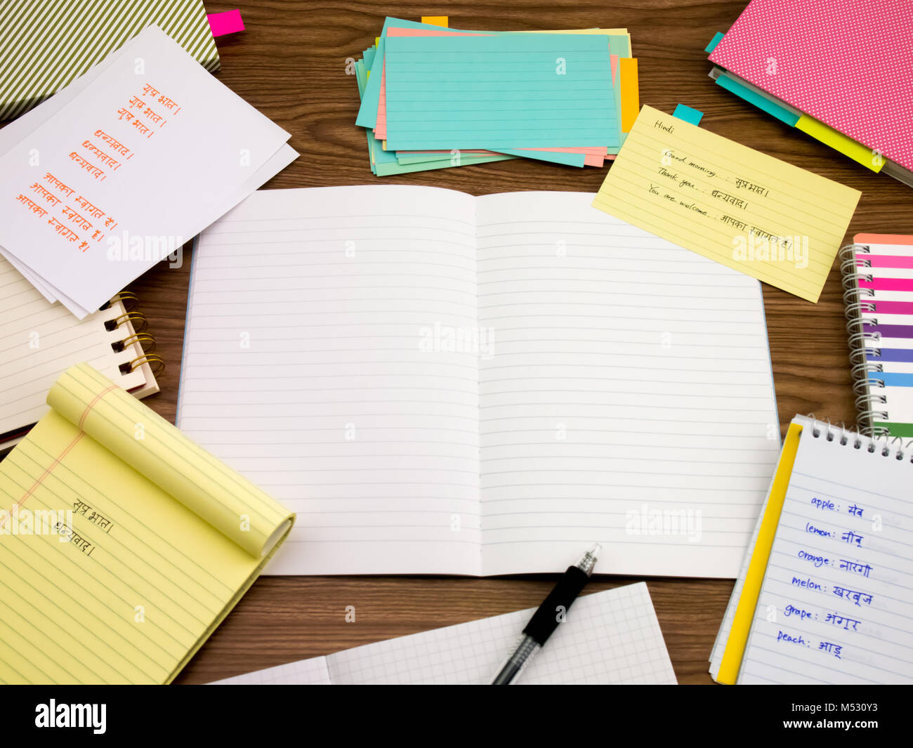 Hindi; Learning New Language Writing Words on the Notebook Stock Photo