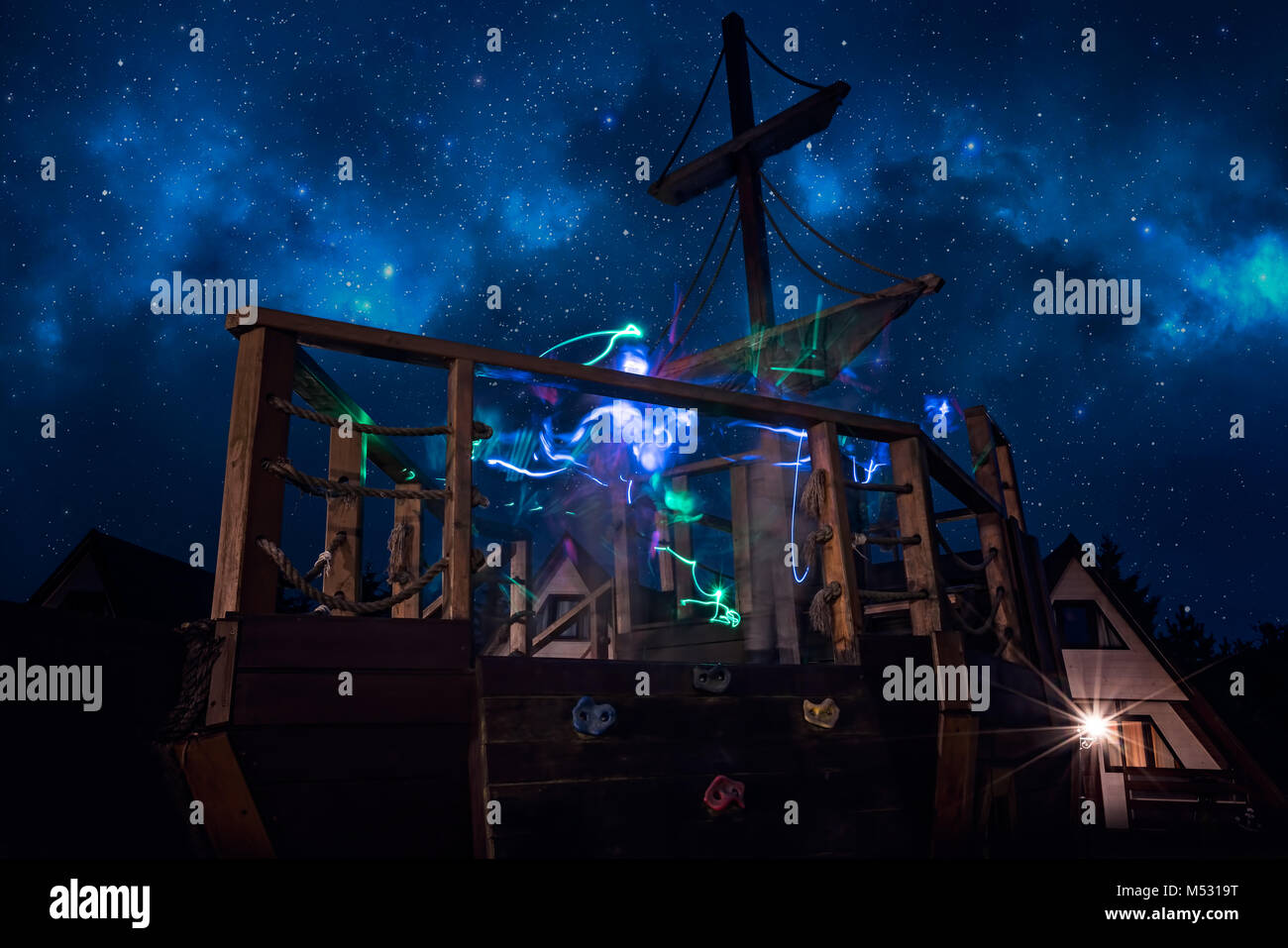 Colorful ghostly lighttrails on a deck of a pirate ship Stock Photo