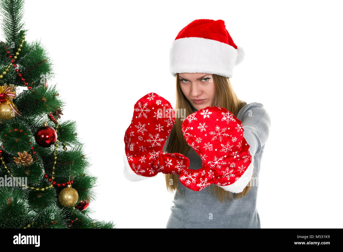 girl in santa claus hat and winter mittens on white Stock Photo