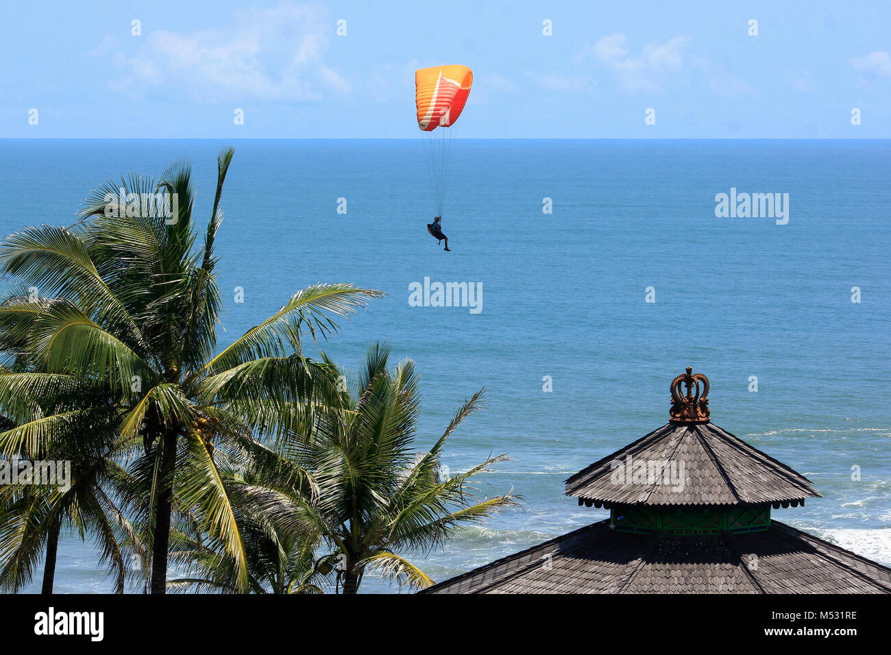 Parangtritis Beach, Yogyakarta, Indonesia, 18th February 2018. Paraglider flies quietly under the sunny weather in Jogja Air Show. Stock Photo
