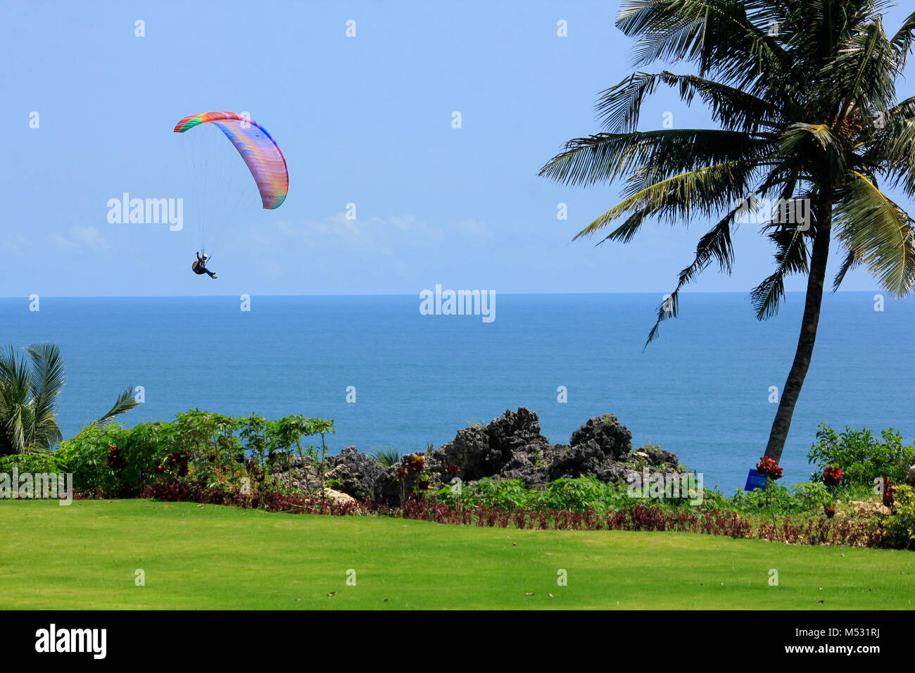 Parangtritis Beach, Yogyakarta, Indonesia, 18th February 2018. Paraglider flies quietly under the sunny weather in Jogja Air Show. Stock Photo