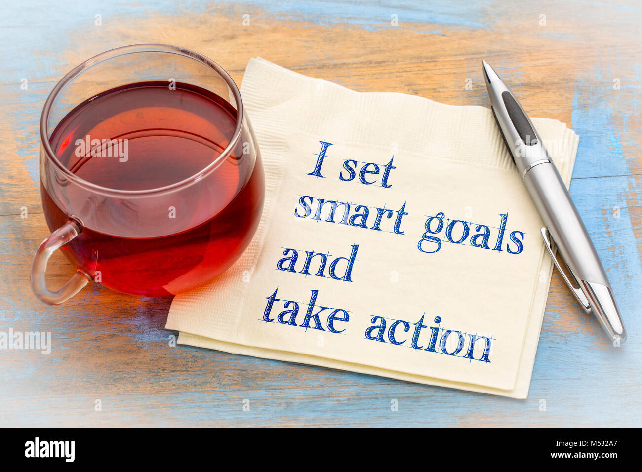 I set smart goals and take action - positive handwriting on a anapkin with a cup of tea Stock Photo