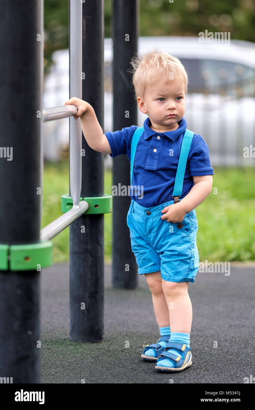 Toddler boy at playground wearing shorts and suspenders Stock Photo Alamy