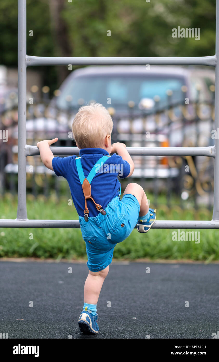 Toddler boy at playground wearing shorts and suspenders Stock Photo Alamy