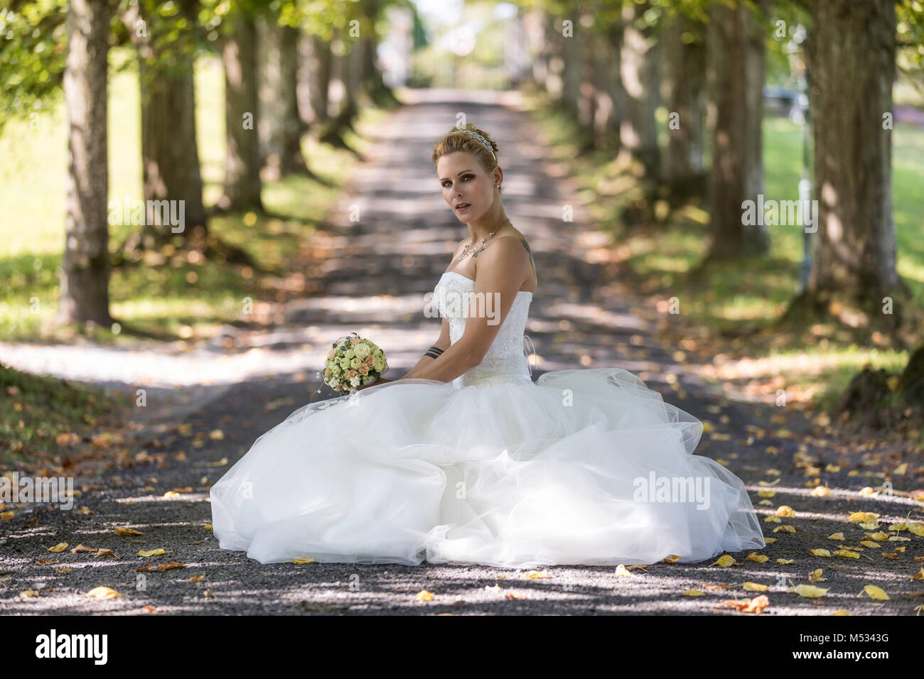 Young blond woman in the white wedding dress Stock Photo