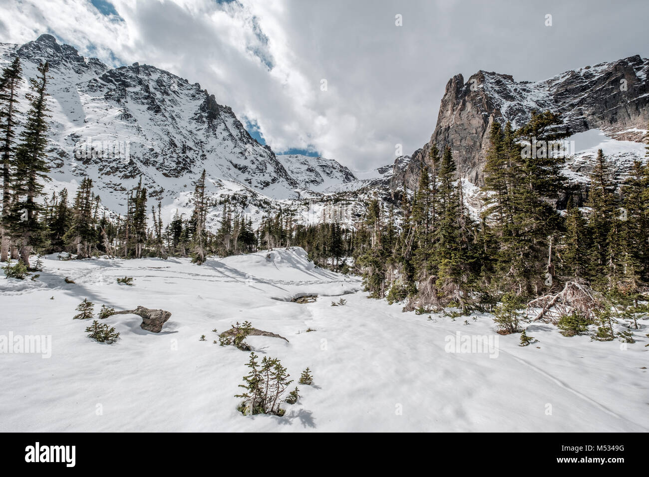 Snowy landscape with rocks and mountains Stock Photo - Alamy