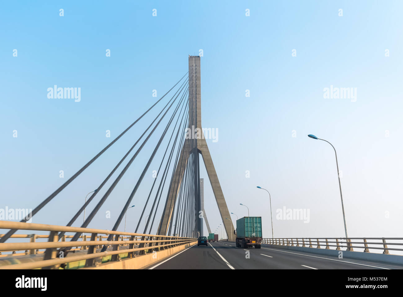 cable-stayed bridge with container truck Stock Photo