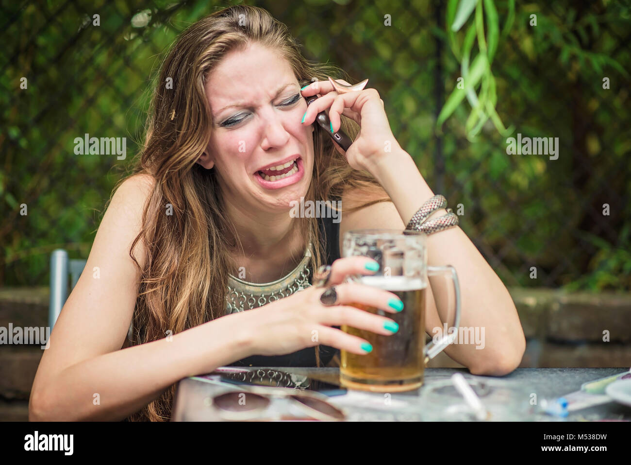 Woman breaking up over her cell phone Stock Photo