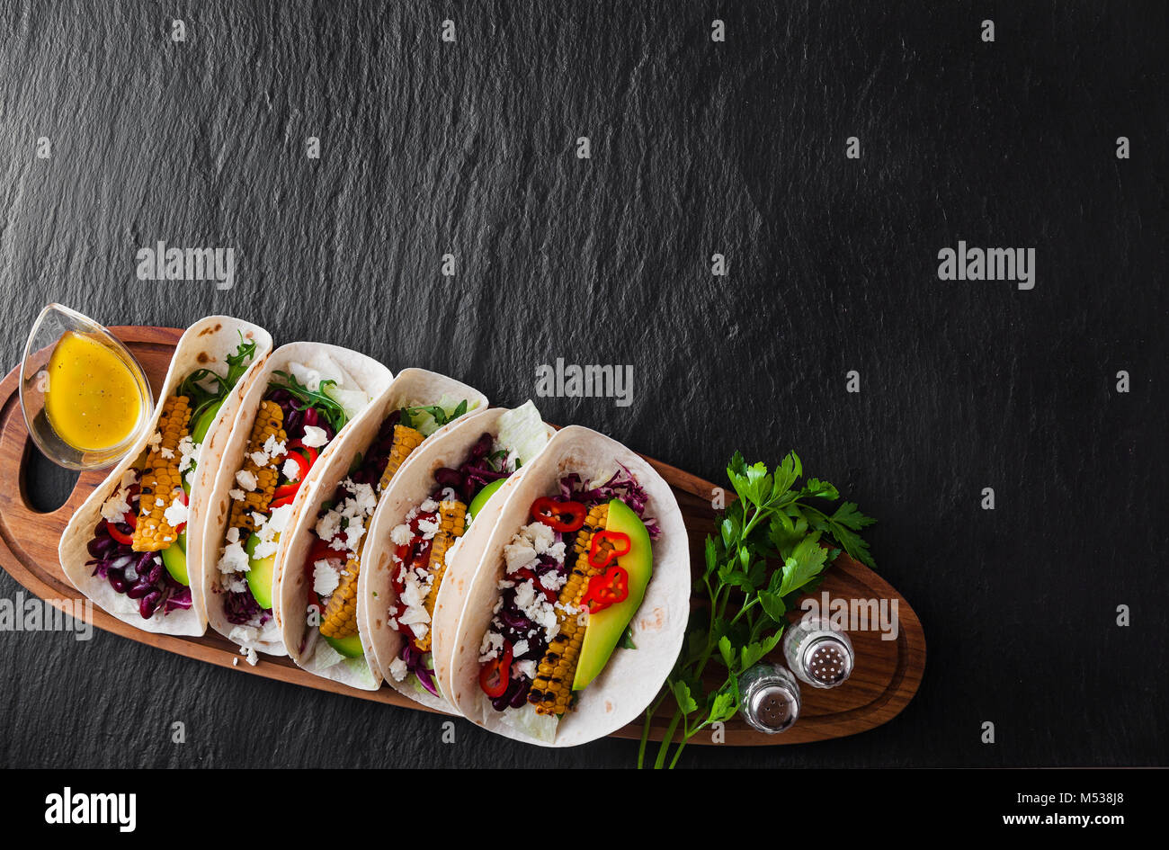 Mexican tacos with avocado, grilled corn, red cabbage slaw and chili