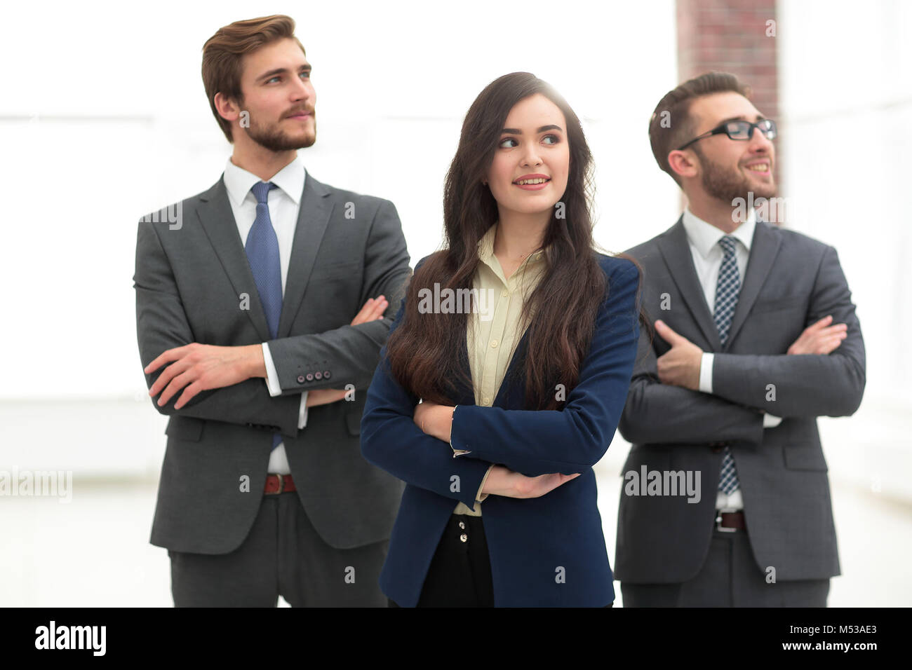 Smiling business team standing with arms crossed Stock Photo - Alamy