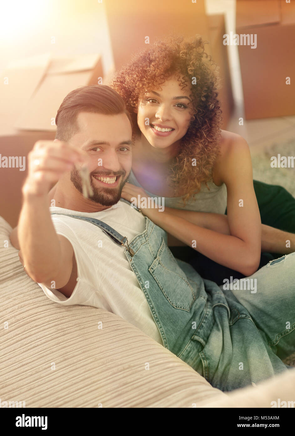 young couple holding the key to a new apartment Stock Photo - Alamy