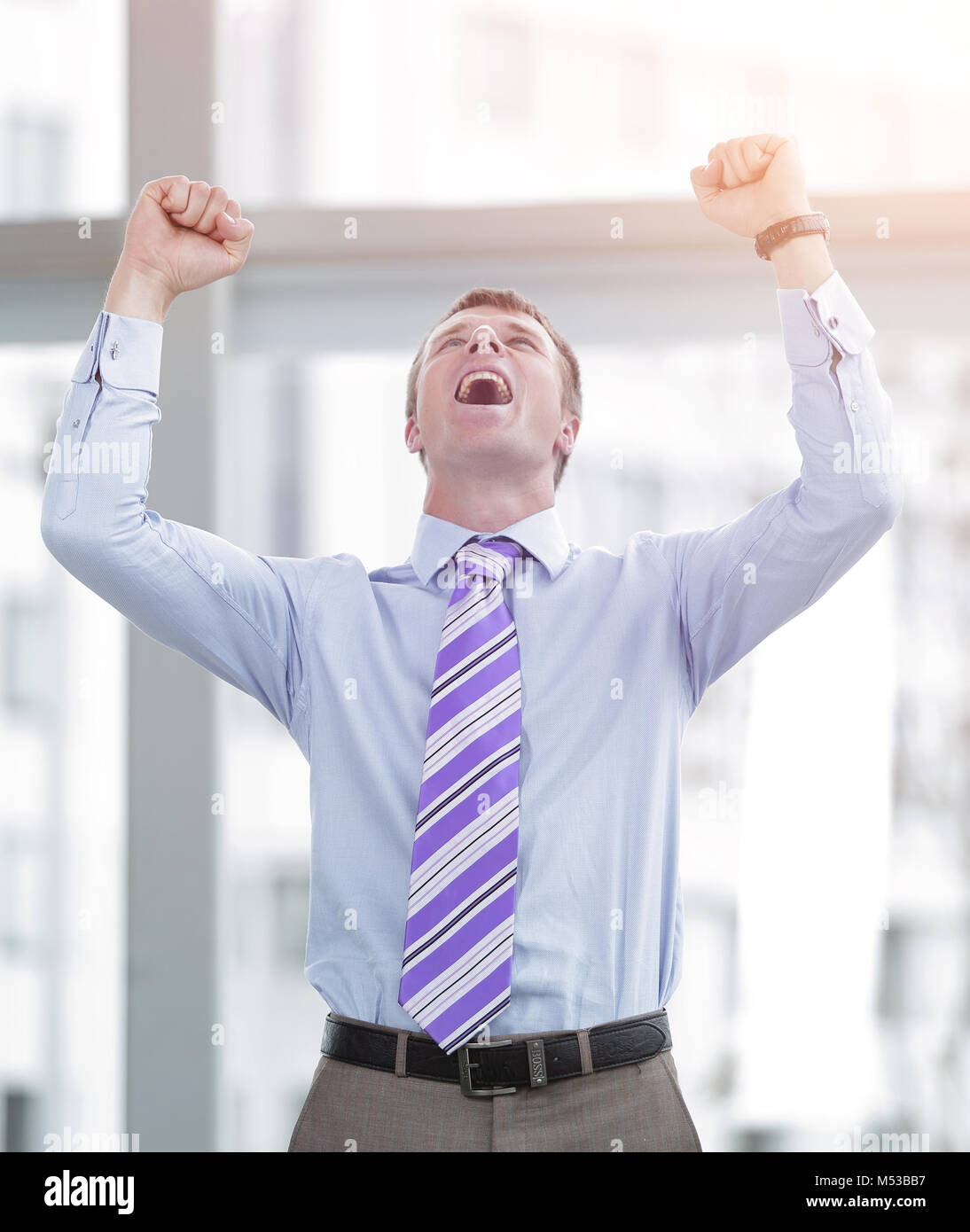Businessman celebrating with his fists raised in the air Stock Photo ...