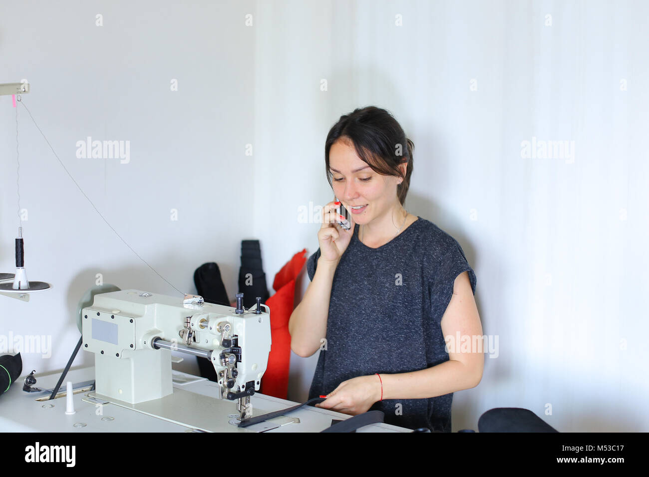 Seamstress sewing belt using sewing machine Stock Photo Alamy