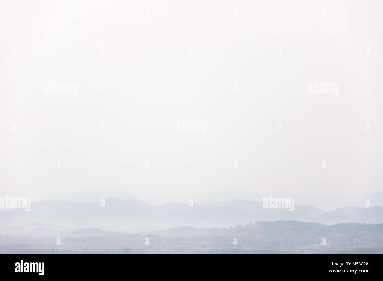 Minimal mountain on top fog with white space background Stock Photo
