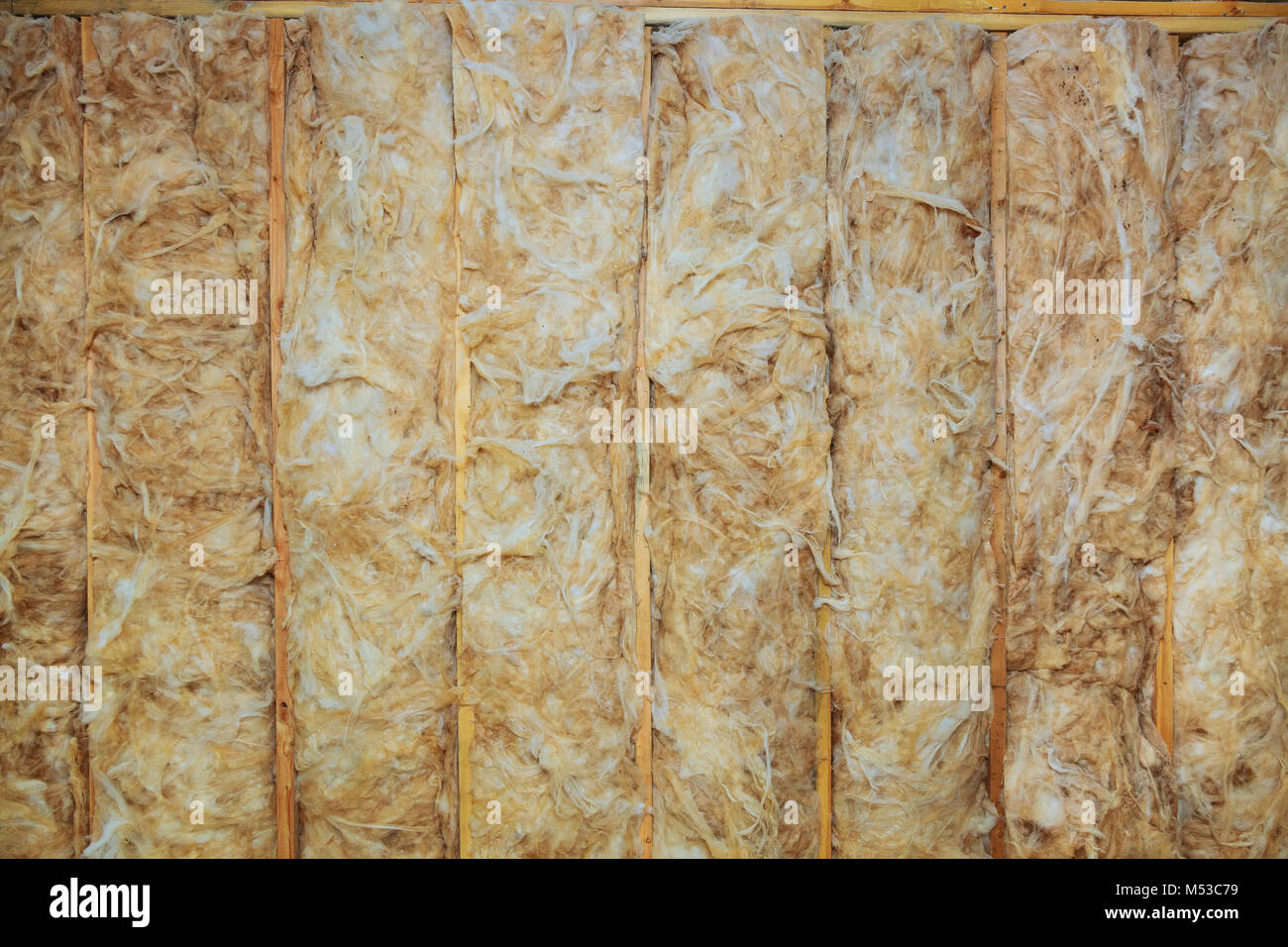 Inside wall insulation in wooden house, building under construction Stock Photo