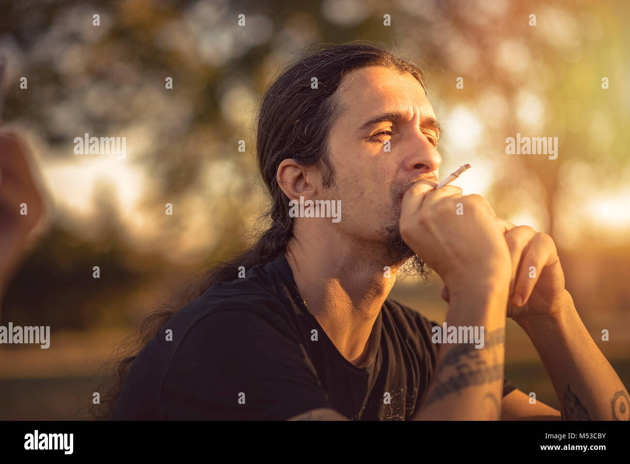 Long haired smoker hi-res stock photography and images - Alamy