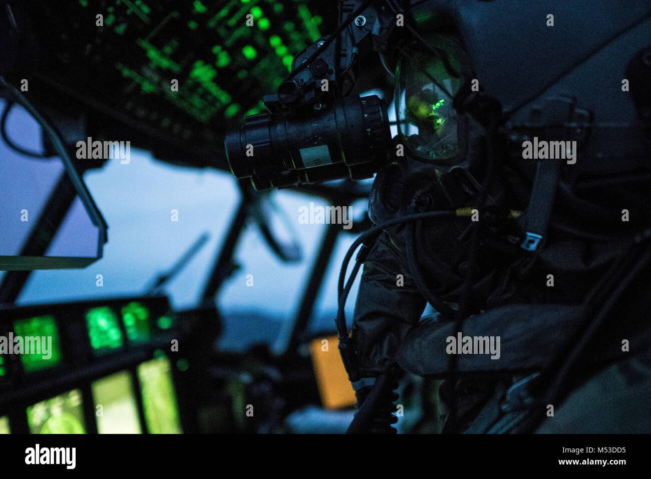 A U.S. Air Force 17th Special Operations Squadron pilot executes in-flight training with aircrew eye and respiratory protection system (AERPS) equipment Jan. 31, 2018, off the coast of Okinawa, Japan. Aircrew took turns donning equipment in-flight, while the remainder of the crew monitored them as a safety precaution. (U.S. Air Force photo by Capt. Jessica Tait) Stock Photo
