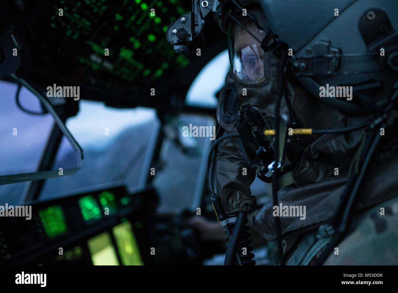 A U.S. Air Force 17th Special Operations Squadron pilot executes in-flight training with aircrew eye and respiratory protection system (AERPS) equipment Jan. 31, 2018, off the coast of Okinawa, Japan. Aircrew took turns donning equipment in-flight, while the remainder of the crew monitored them as a safety precaution. (U.S. Air Force photo by Capt. Jessica Tait) Stock Photo