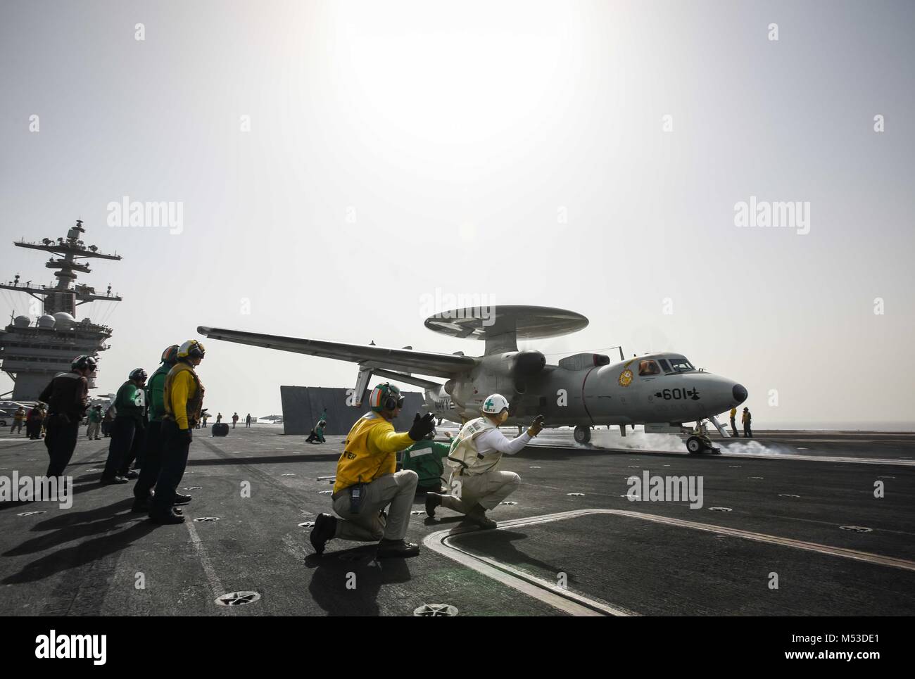 180219-N-VN584-1657 ARABIAN GULF (Feb. 19, 2018) An E-2C Hawkeye, assigned to the Sunkings of Carrier Airborne Early Warning Squadron (VAW) 116, readies for launch on the flight deck of the aircraft carrier USS Theodore Roosevelt (CVN 71). Theodore Roosevelt and its carrier strike group are deployed to the U.S. 5th Fleet area of operations in support of maritime security operations to reassure allies and partners and preserve the freedom of navigation and the free flow of commerce in the region. (U.S. Navy photo by Mass Communication Specialist 3rd Class Alex Corona/Released) Stock Photo